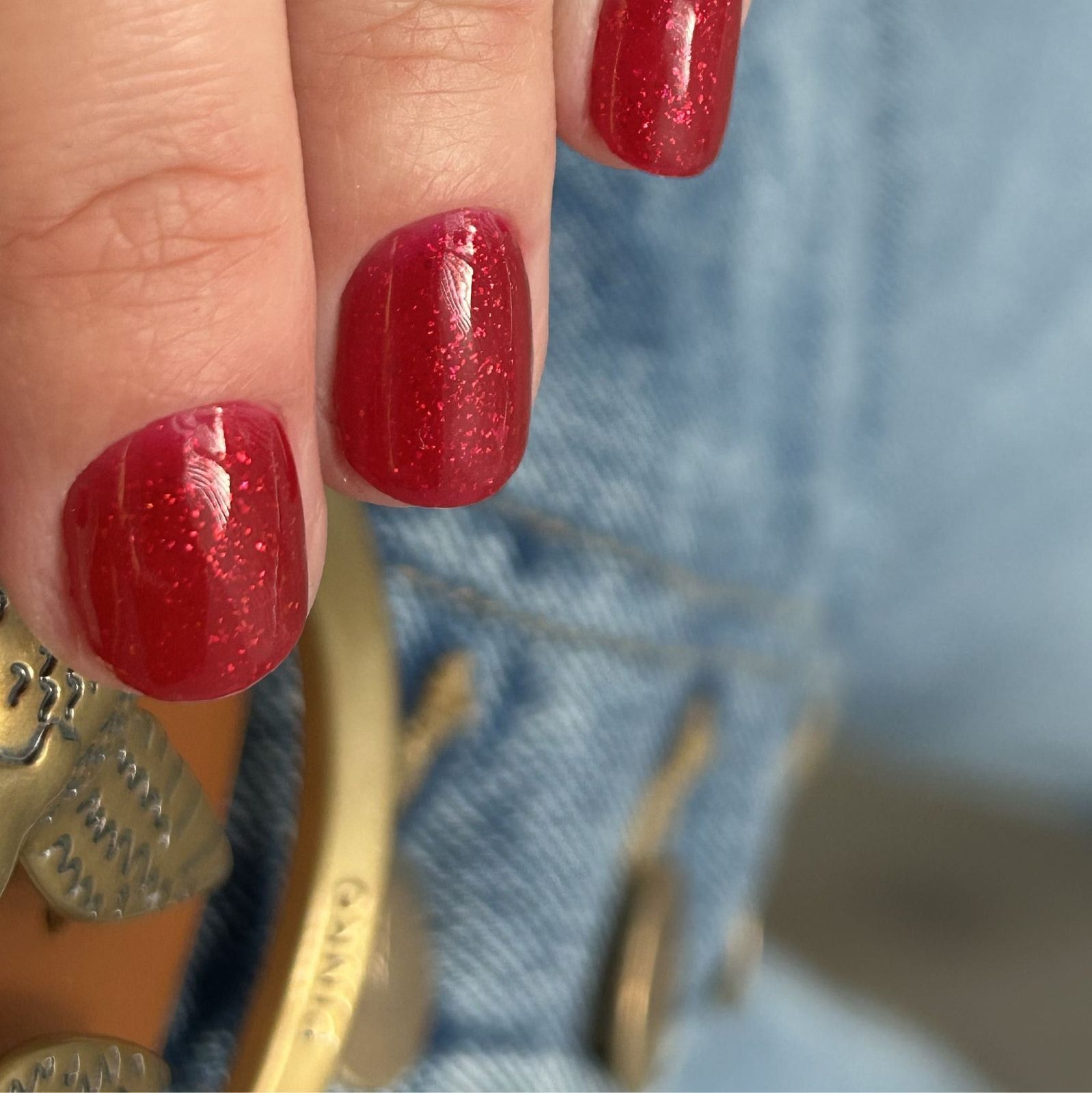 Rode glitternagels op spijkerstof